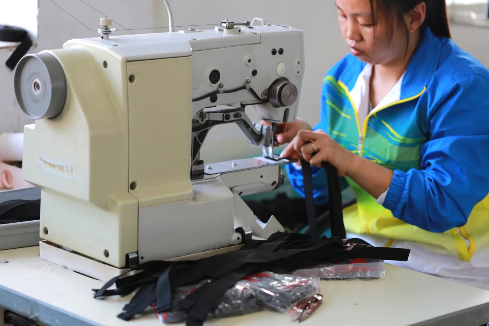 Worker sewing a bag in the Baigou workshop